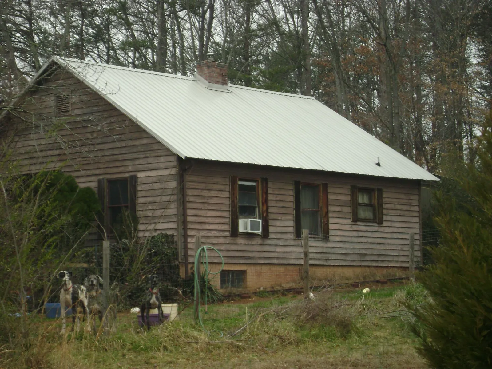 White metal roof on an old wood sided farmhouse, from a Metal Roof Installation job in Marble